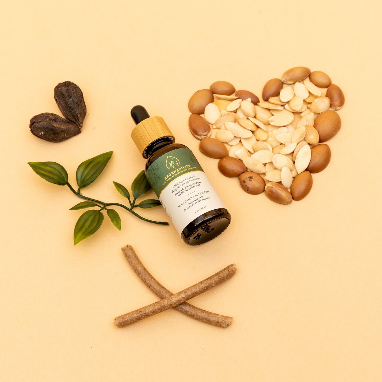 Arganability pure argan oil of Morocco with argan kernel and argan nutts forming a heart